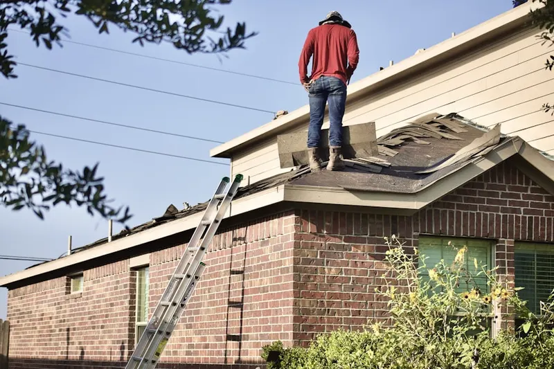 Professional roofer working on a residential roof in Deansboro